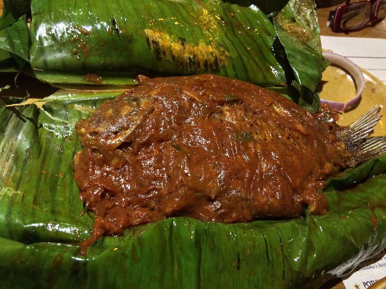 Karimeen pollichathu opened on a banana leaf